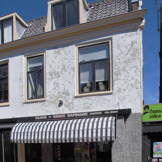 Pand met gepleisterde lijstgevel in topgevel eindigend