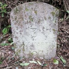 Milestone, 20m E of entrance to camping park