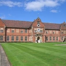 Stables at Arbury Hall and  attached wall and gate pier to left