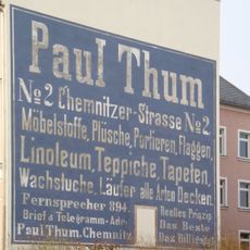 Geschäftswerbung (gemalt) auf der Giebelseite eines Mietshauses (zur Krügerstraße) Frankenberger Straße 196