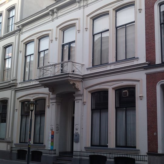 Pand dat deel uitmaakt van een in het derde kwart van de 19e eeuw als een symmetrisch geheel ontworpen straatwand