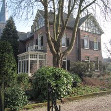 Dubbele villa met aangebouwde schuurtjes en tuinhek