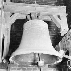 Tombstones, baptismal font and two bells in Sint-Corneliuskerk
