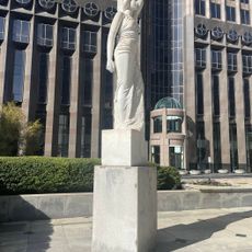 A statue of marble of a woman not quite yet completely formed