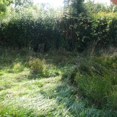 Milestone, near rt-angle bend in hedge 187 yds W of turning to Marston Hill.