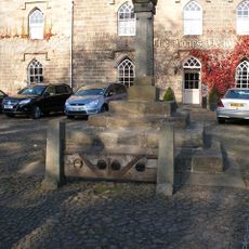 Village cross with sundial and stocks