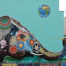 Elephant with world balloon