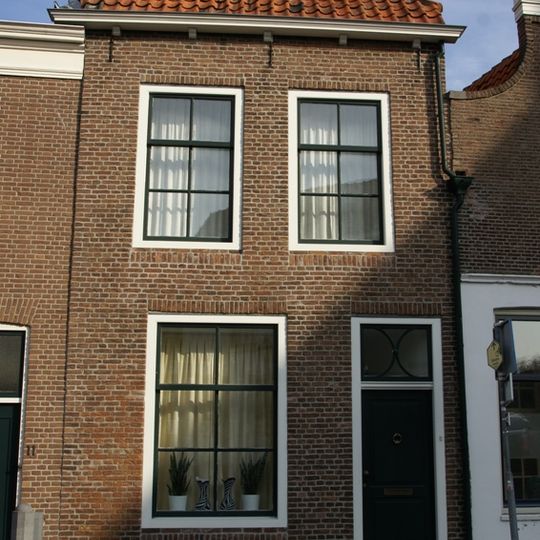 Woonhuis met gevel onder rechte lijst met consoles. Late Empire-schuif- en draairamen. Parterre en verdieping. Schilddak