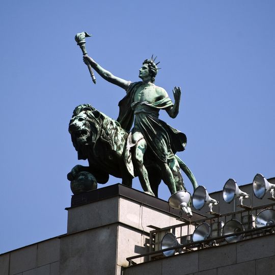 Lion and genius on Česká národní banka building in Prague