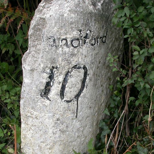 Milestone, 500m S of jct with A35;